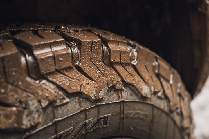 a muddy tire on an overlanding rig